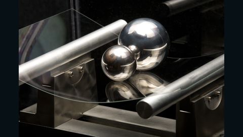 The new Corning glass supports two steel balls, showing its strength and flexibility.