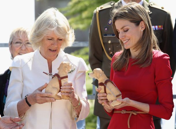Prince Charles's wife Camilla, Duchess of Cornwall (left), was offered a more unusual keepsake -- a model of a guide dog -- during a visit to a Guide Dogs Center in Madrid, Spain, in March 2011.