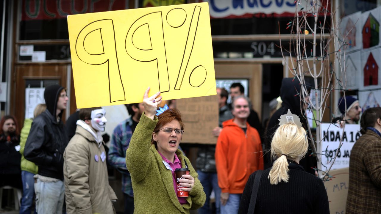 Activists of "occupy Iowa caucuses" shout slogans as they march along a street in Des Moines, Iowa, on December 31. 