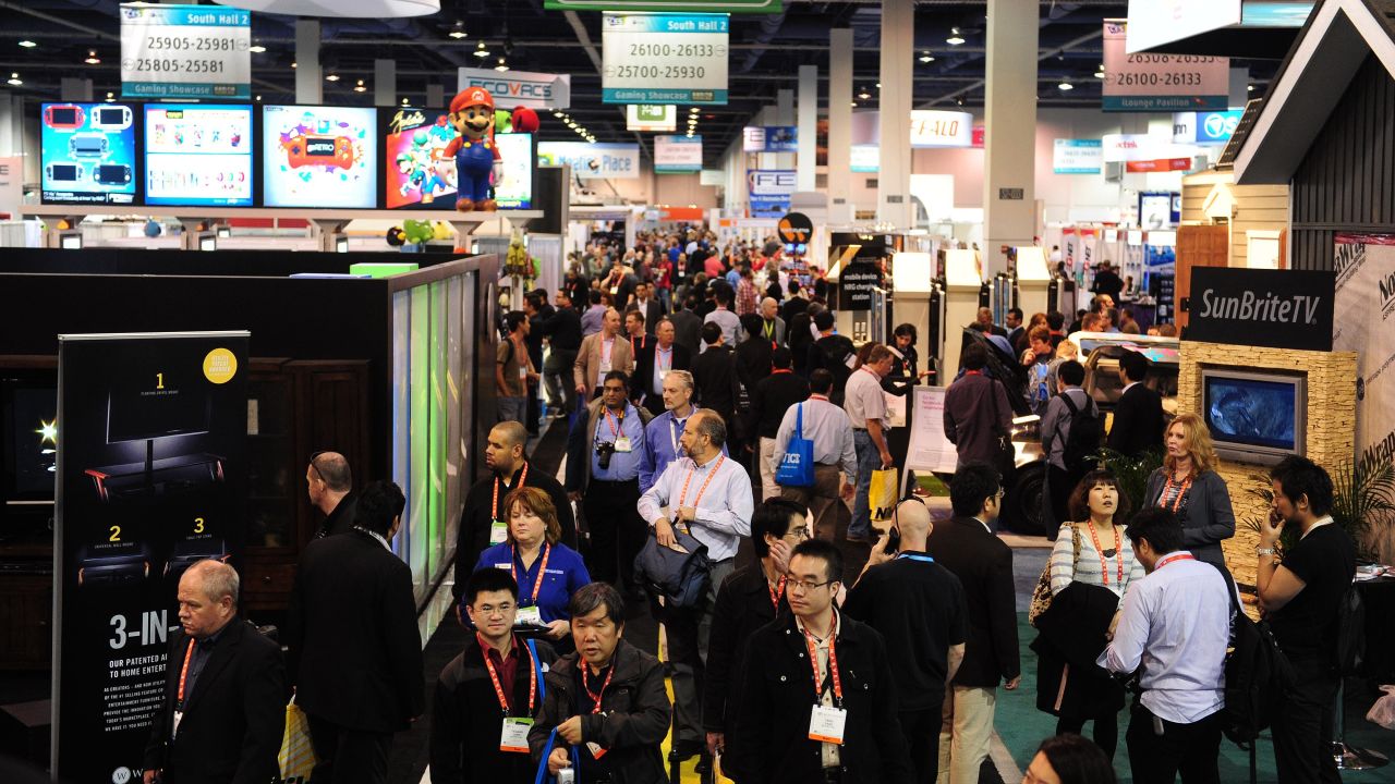 Visitors make their way between display booths at the International Consumer Electronics Show in Las Vegas, Nevada.