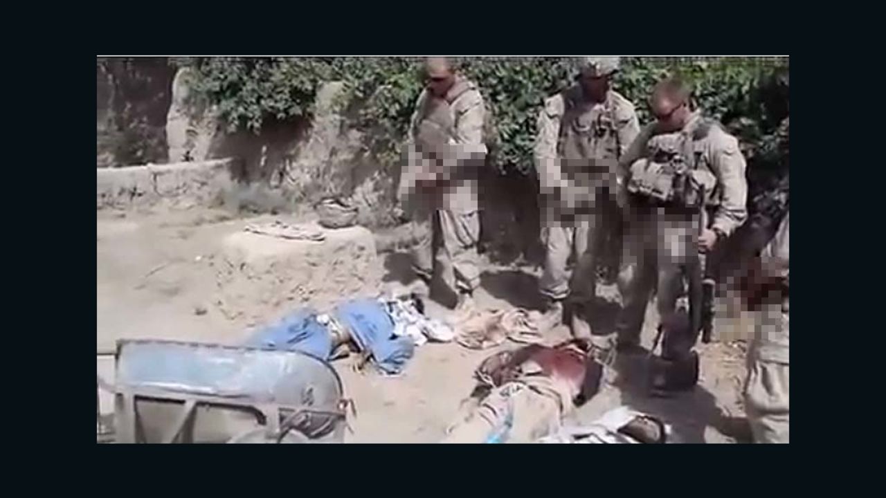 A pixilated still from a video purporting to show U.S. Marines urinating on dead Taliban fighters