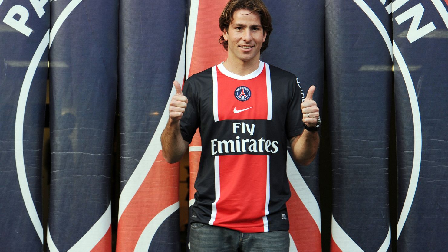 Maxwell parades in his new Paris St Germain kit after completing his signing from Barcelona.