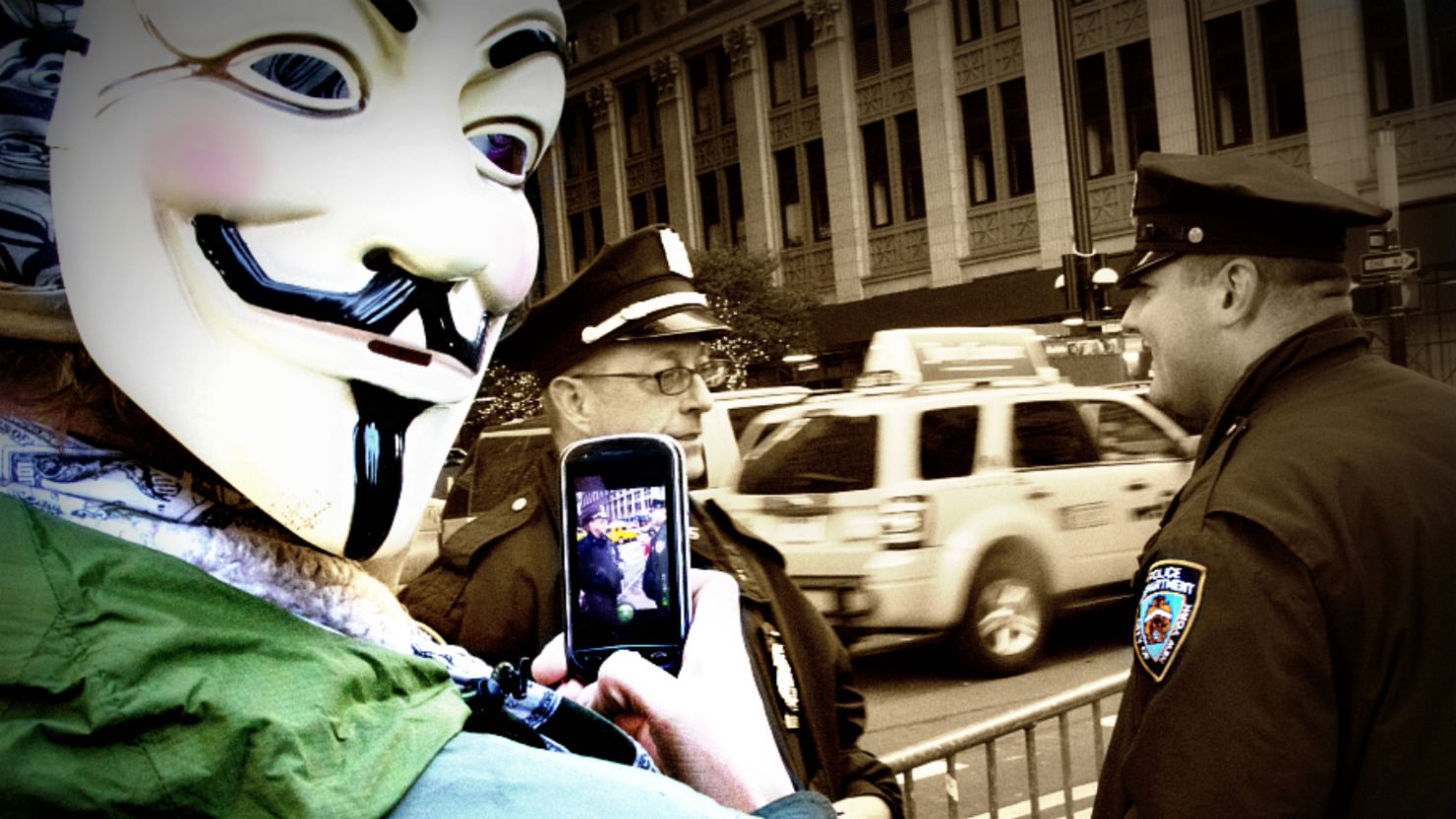 A member of Anonymous keeps an eye on NYPD officers during a recent Occupy Wall Street protest.