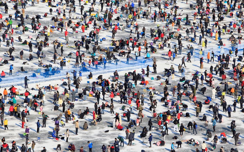 In South Korea, anglers cast lines through holes into a frozen river during an ice fishing competition at the Hwacheon Sancheoneo Ice Festival.