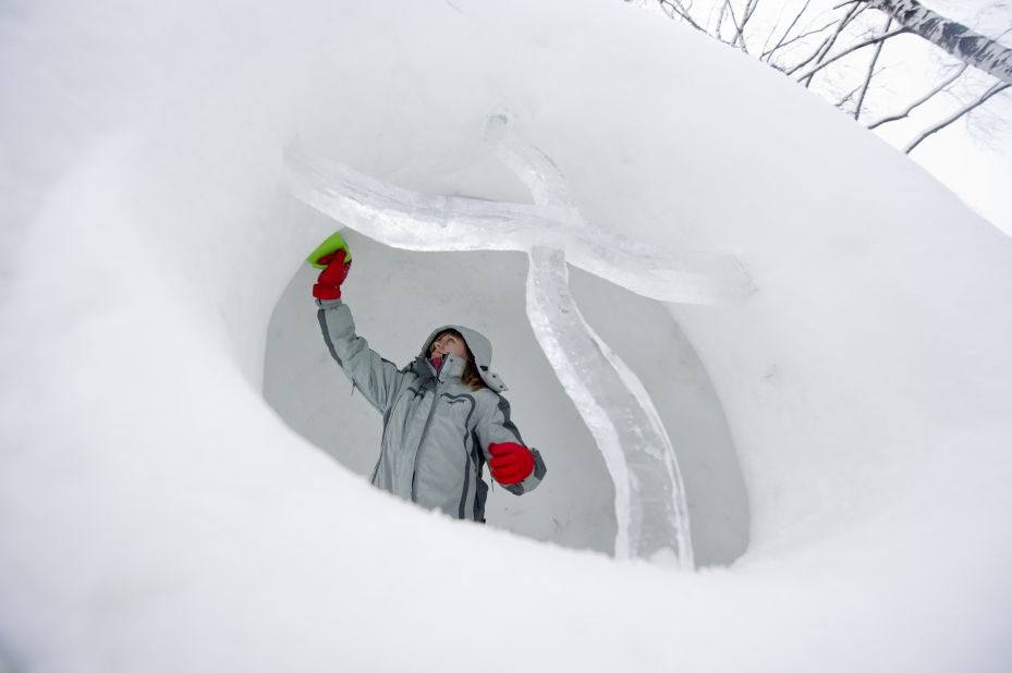 A woman works on a sculpture January 10 to be displayed at a snow festival in Moroz (Frost) City in Moscow.