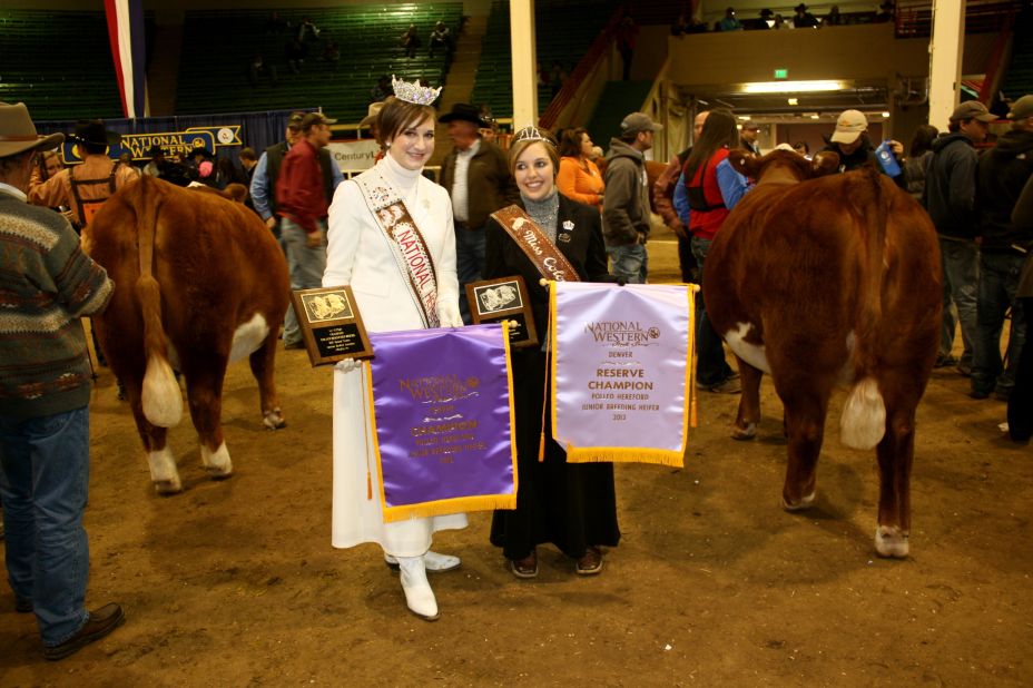 National Hereford Queen Amanda Bacon, left, and Colorado Hereford Queen Brooke Hinojosa hand out the ribbons to all the winning Hereford bulls.