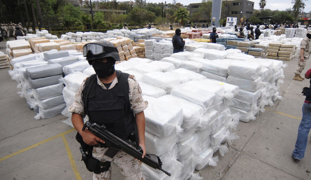 Mexican Federal Police stand guard over 105 tons of marijuana seized in Tijuana, Mexico, in October 2010. Smuggling remains a booming business. For example, south of the border it costs $2,000 to produce a kilo of cocaine from leaf to lab, according to the DEA. In America, a kilo's street value is significantly higher.