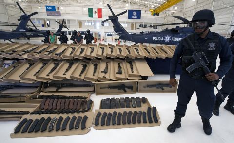 The cartels arm themselves heavily. Here, Mexican Federal Police display a large cache of high-powered weapons, grenades, ammunition and 2 kilos of cocaine, all seized from the Zetas cartel in October 2010.