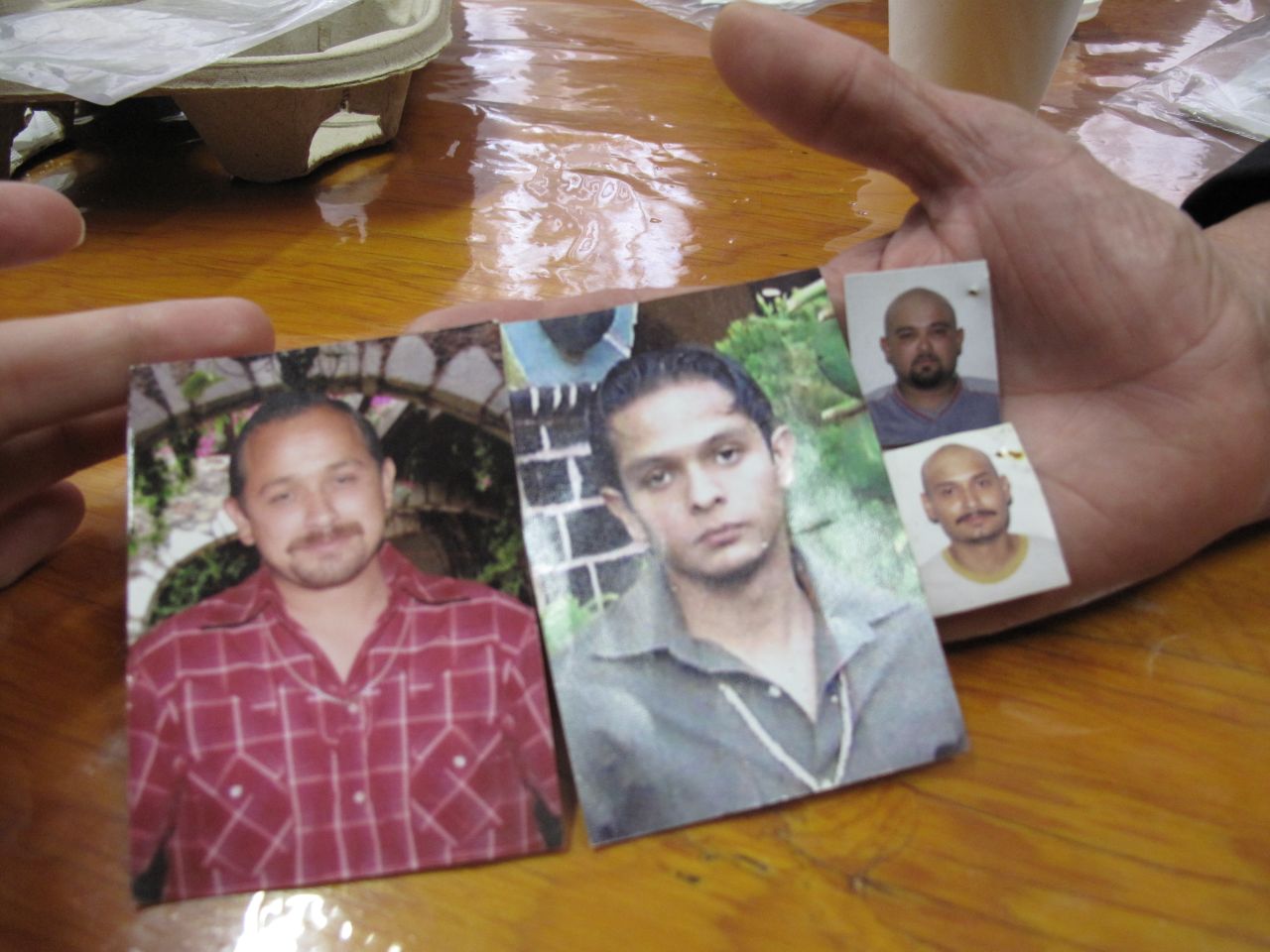 Maria Herrera Magdalena holds photos of her four missing children: Salvador, Raul, Gustavo and Luis Armando. "When I start to talk about my sons, I can't stop crying," she says.