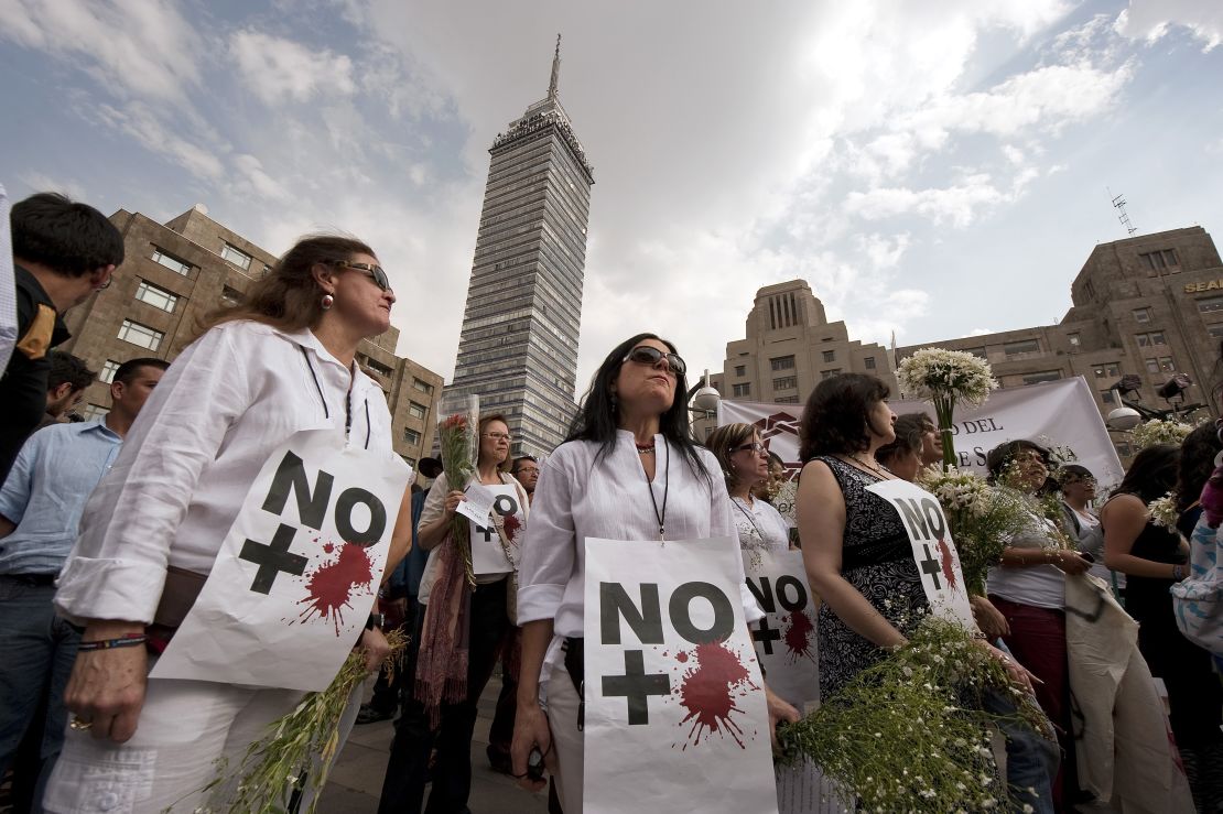 Anti-violence activists protest in Mexico City in April 2011. Their signs read, "No more blood."