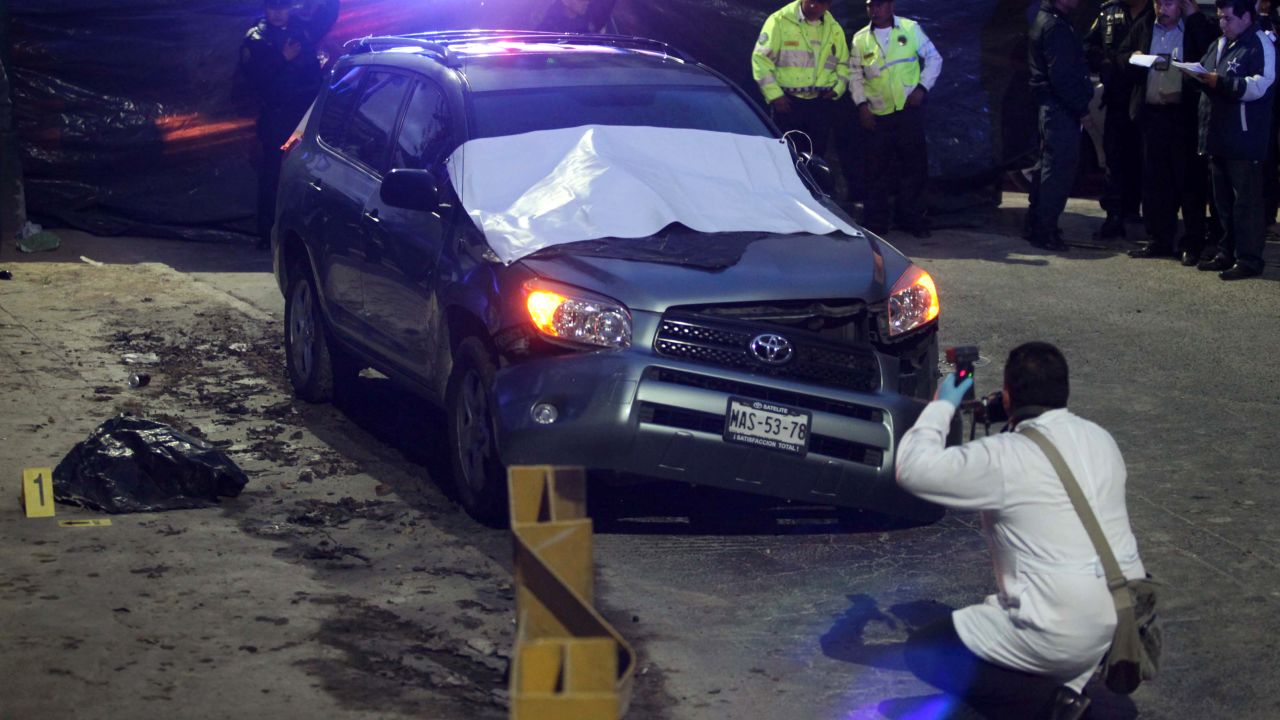 A forensic photographer documents the site where two severed heads were found on October 3, 2011.
