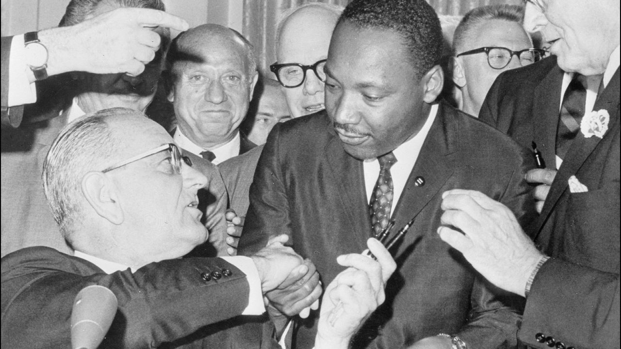 President Lyndon Johnson shakes hands with Martin Luther KIng Jr. after signing of the 1964 Civil Rights Act at the White House..