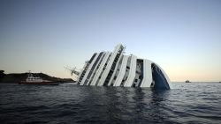 View of the Costa Concordia on January 14, 2012, after the cruise ship ran aground and keeled over off the Isola del Giglio, last night. Three people died and several were missing after the ship with more than 4,000 people on board ran aground sparking chaos as passengers scrambled to get off. The ship was on a cruise in the Mediterranean, leaving from Savona with planned stops in Civitavecchia, Palermo, Cagliari, Palma, Barcelona and Marseille,' the company said. AFP PHOTO / FILIPPO MONTEFORTE (Photo credit should read FILIPPO MONTEFORTE/AFP/Getty Images) 