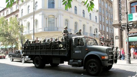 A truck carries troops through the historic center of Mexico City, where major cartel violence has not been a part of daily life.