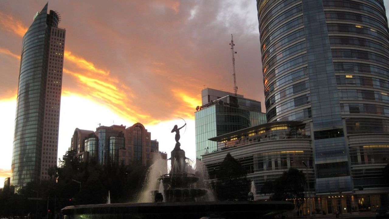 Towering buildings line Mexico City's Reforma Avenue. Once dogged by a crime-ridden reputation, the city is now a refuge.
