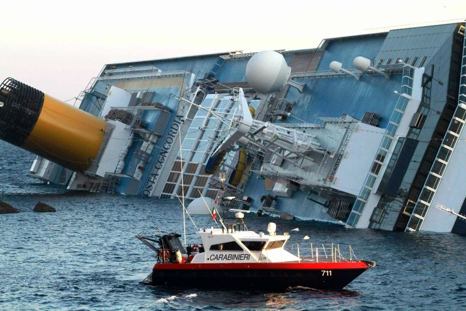 Italian police assist in the rescue after the cruise ship ran aground near the island.