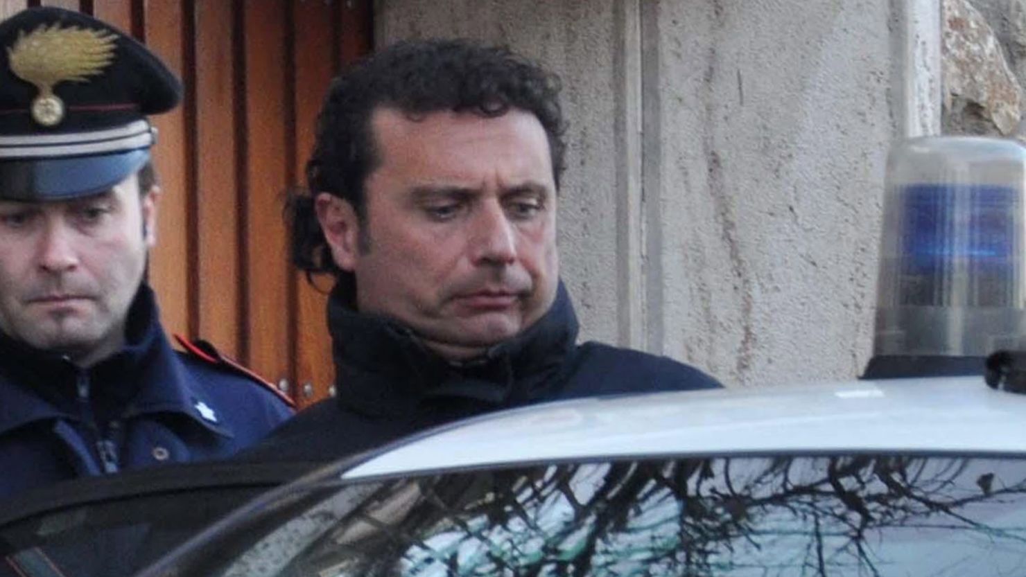 Captain of the Costa Concordia cruise liner Francesco Schettino is escorted by an Italian policeman in Grosseto earlier this year