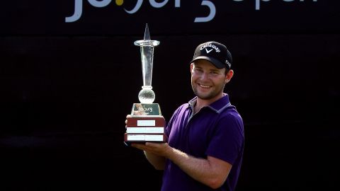Branden Grace shows off his Joburg Open trophy after claiming the first European Tour win of his career.