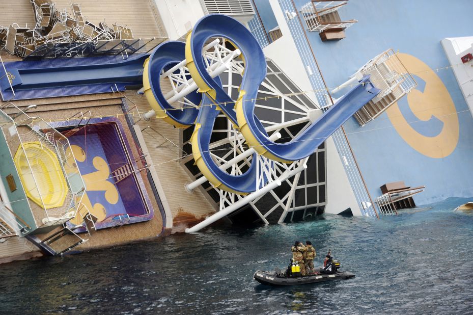 Military rescuers patrol next to the listing Costa Concordia on January 15. A spiraling water slide can be seen on the deck.