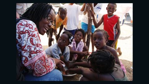 Yolette Etienne, here with children in Haiti, says civic participation and community projects are crucial to recovery