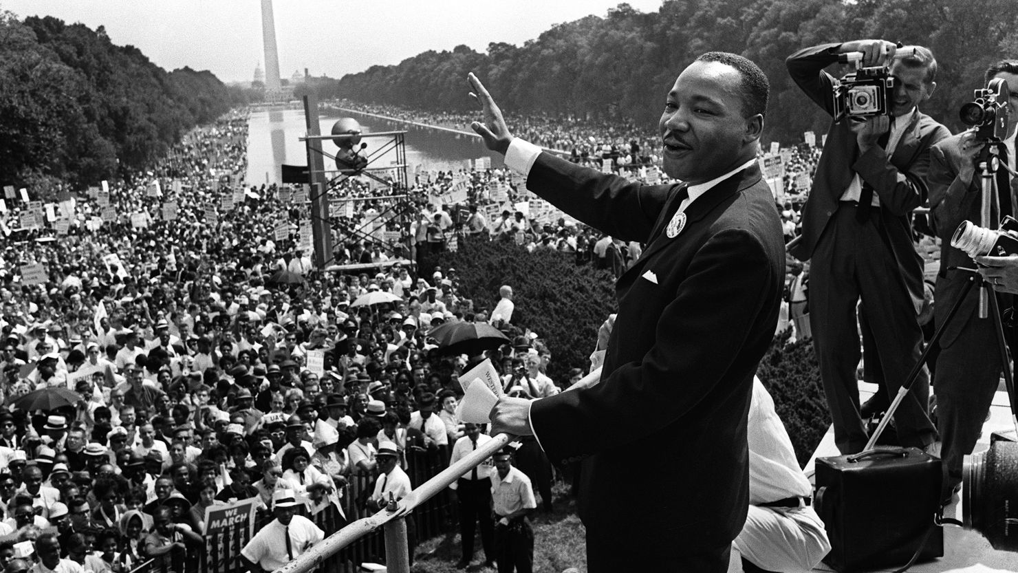 Dr. Martin Luther King Jr. waves to the throngs of people gathered in August 1963 during the March on Washington.