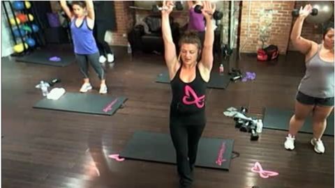 A Flirty Girl Fitness instructor teaches a class that's streaming live online to subscribers.