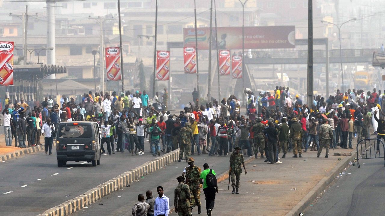 Soldiers march toward protesters after the government deployed troops to stop protests against rising oil prices in Nigeria.