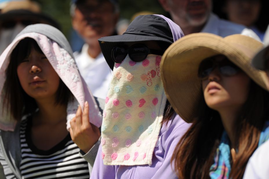 Spectators wear towels to beat the heat as Tatsuma Ito of Japan played Nicolas Mahut of France on the fourth day of the 2012 tournament in Melbourne. 