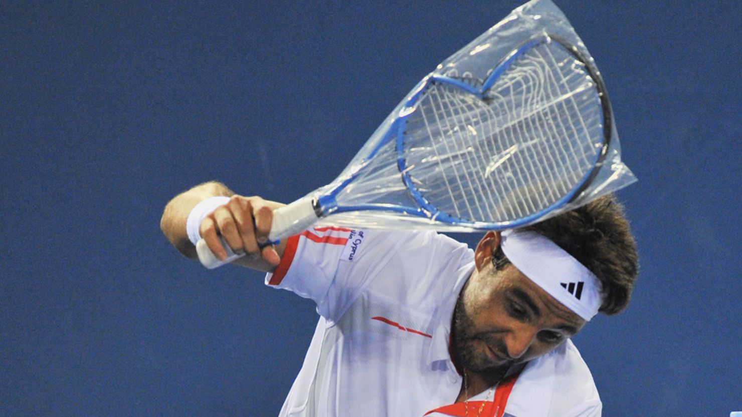 Marcos Baghdatis smashes a new racket during an outburst at the Australian Open. 