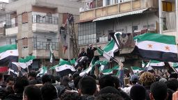Syrian anti-regime demonstrators wave the former Syrian flags in the Khalidiya neighbourhood, said to be under the control of the Free Syrian Army, in the flashpoint city of Homs on January 20, 2012.