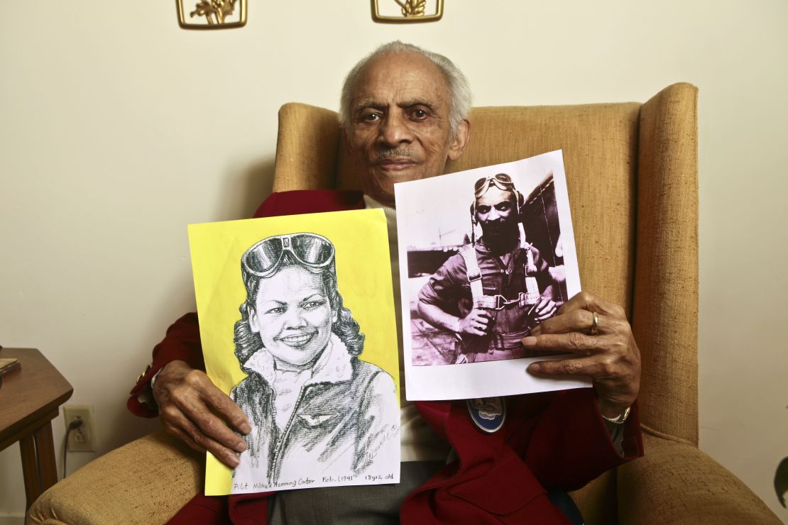 Carter holds a portrait of his wife and a photograph of himself from their flying days.