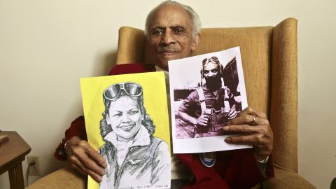Carter holds a portrait of his wife and a photograph of himself from their flying days.