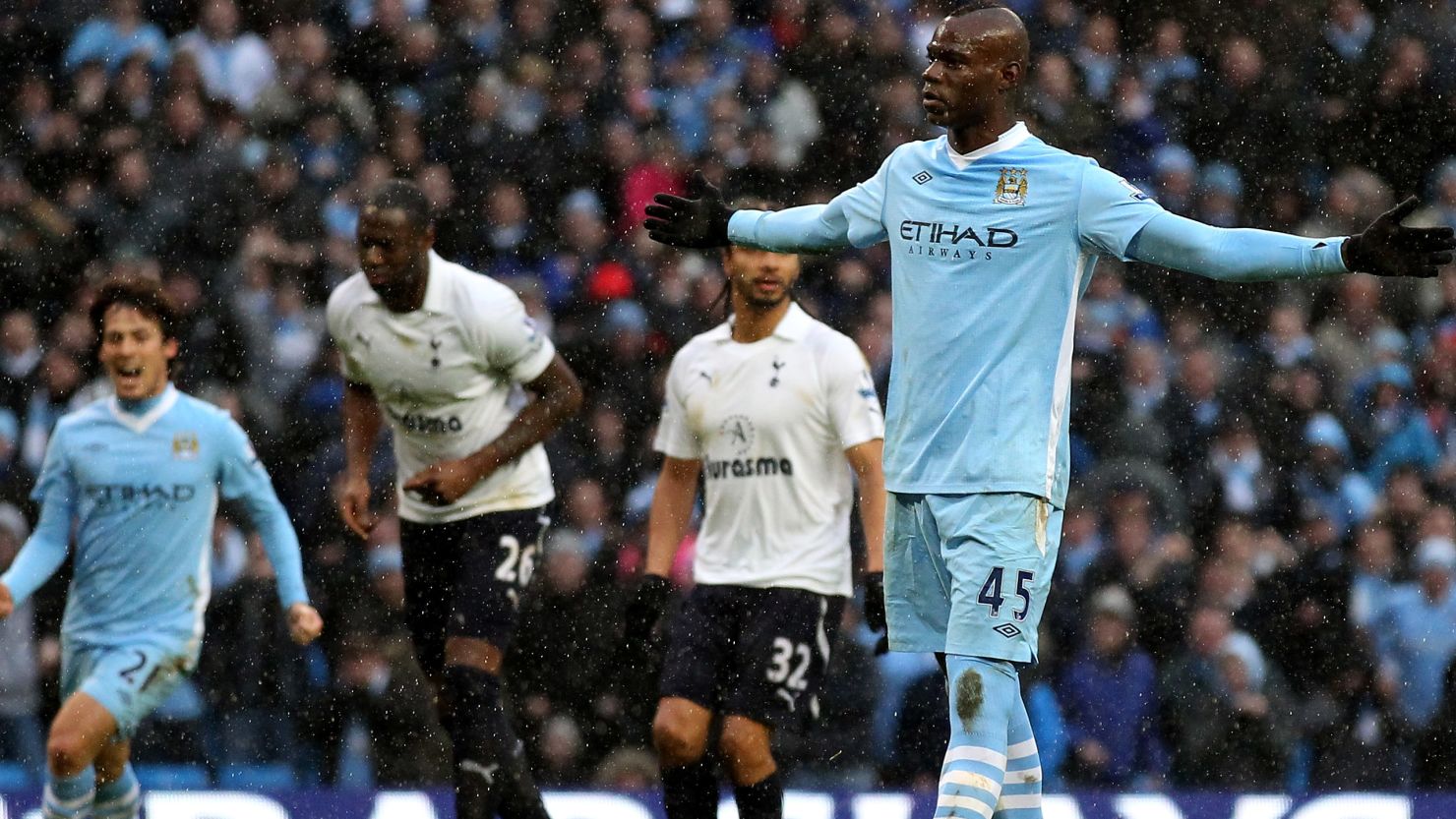 Manchester City's Mario Balotelli celebrates his winning penalty soon after he appeared to kick out at an opponent.