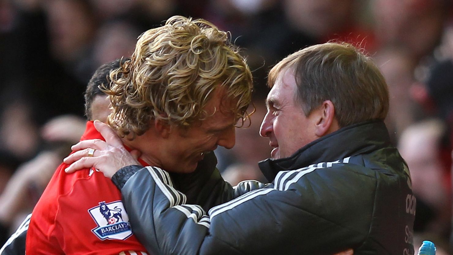 Dirk Kuyt is congratulated by his manager Kenny Dalglish after scoring the winning goal against Manchester United