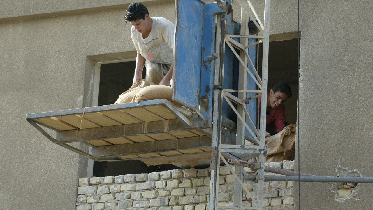 Iraqis work on a construction project in Baghdad in October 2003.
