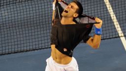 Novak Djokovic rips his shirt off as he celebrates his victory over Rafael Nadal at the Australian Open.