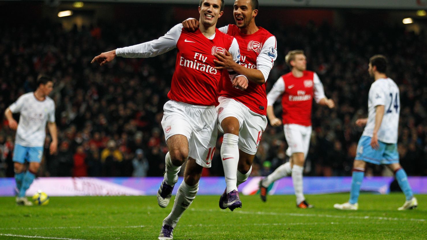 Arsenal's second half goalscorers Robin van Persie and Theo Walcott celebrate their team's second half revival.