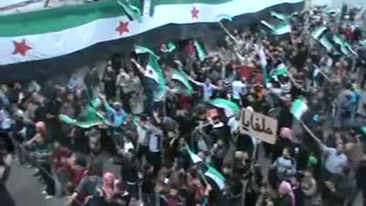Syrian anti-regime protesters wave the country's pre-Baath flag during a demonstration in Helfaya on Sunday.