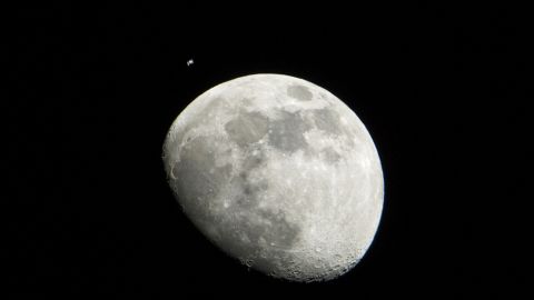 A NASA photograph released this month shows the moon and the international space station.