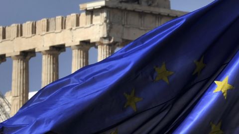 Columns of the Parthenon temple are seen behind an EU flag in Athens on November 4, 2011. 