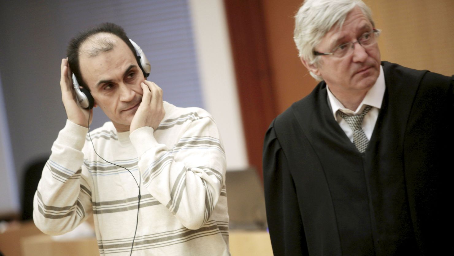 Defendant Shawan Sadek Saeed Bujak Bujak, left, stands next to his lawyer, Arvid Sjoedin, on Monday during his sentencing in Oslo, Norway.