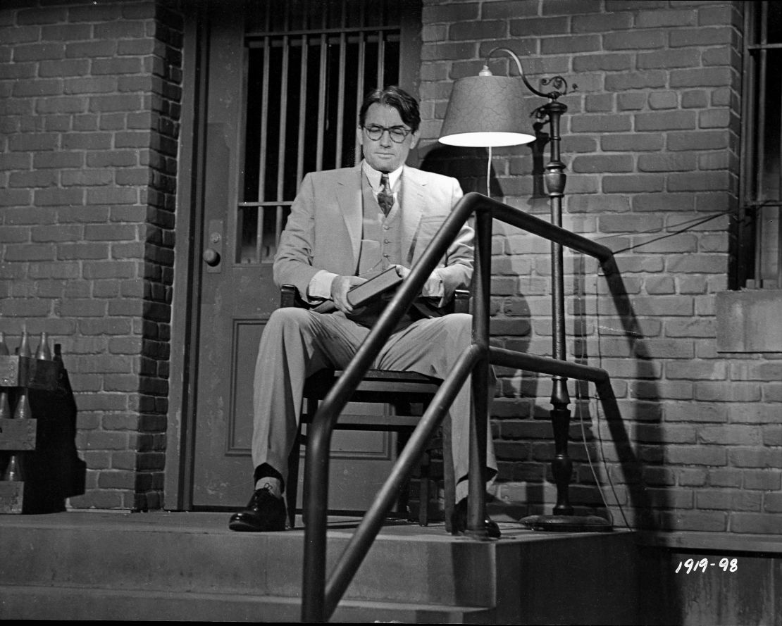 Atticus Finch sits outside the jailhouse to protect Tom Robinson in the movie version of To Kill a Mockingbird