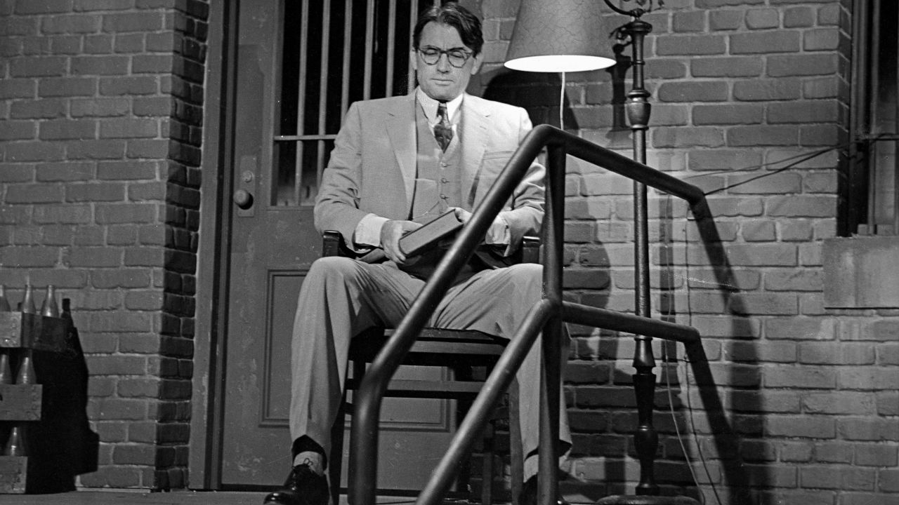 Atticus Finch sits outside the jailhouse to protect Tom Robinson in the movie version of To Kill a Mockingbird