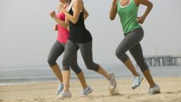 women run beach California exercise