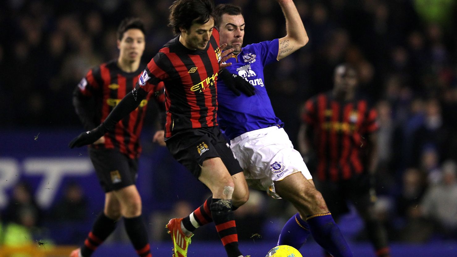 Everton's goalscorer Darron Gibson (R) tussles with David Silva during the league match at Goodison Park 