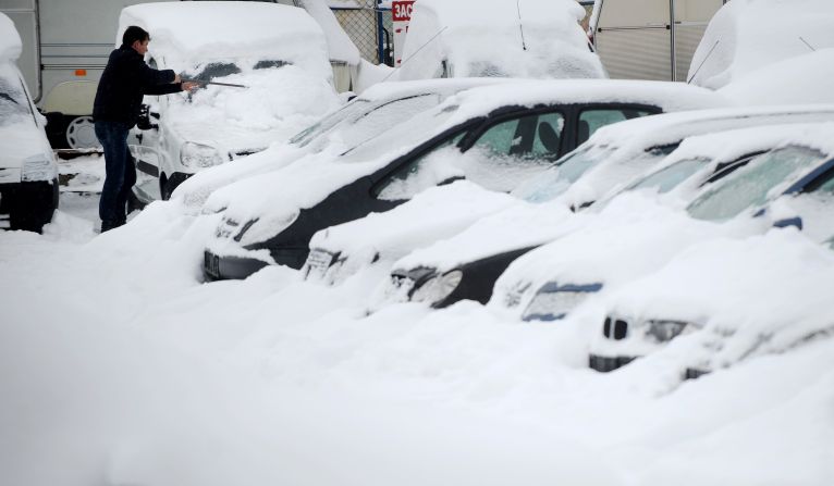 A man clears snow off a vehicle in Sofia on January 27.