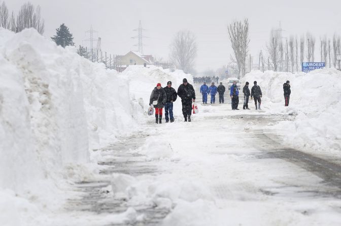 Freshly plowed snow frames a road in Bucharest on January 27.