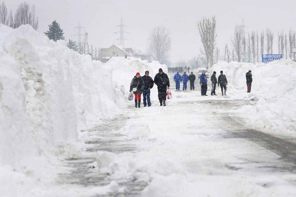 Freshly plowed snow frames a road in Bucharest on January 27.
