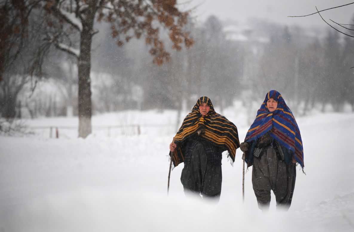 Bulgarian women walk through heavy snow January 28 in Rakovski.