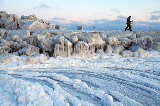 People walk on an ice-covered dam next to frozen Black Sea waters near Bucharest on Wednesday.